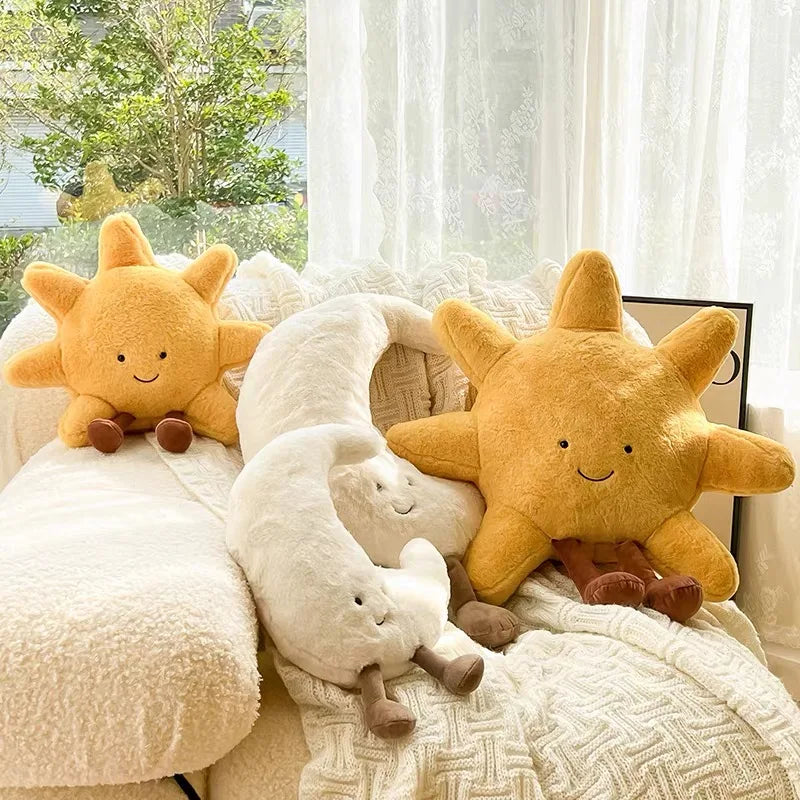 Decorative stuffed animals in the shape of the sun and moon