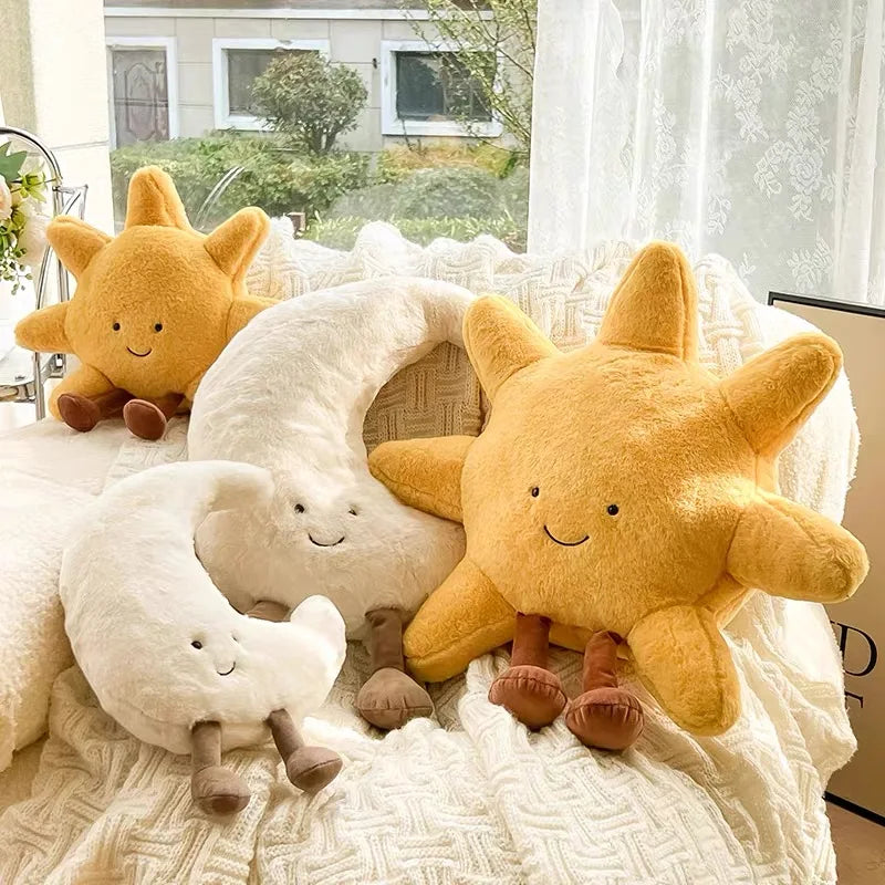 Decorative stuffed animals in the shape of the sun and moon