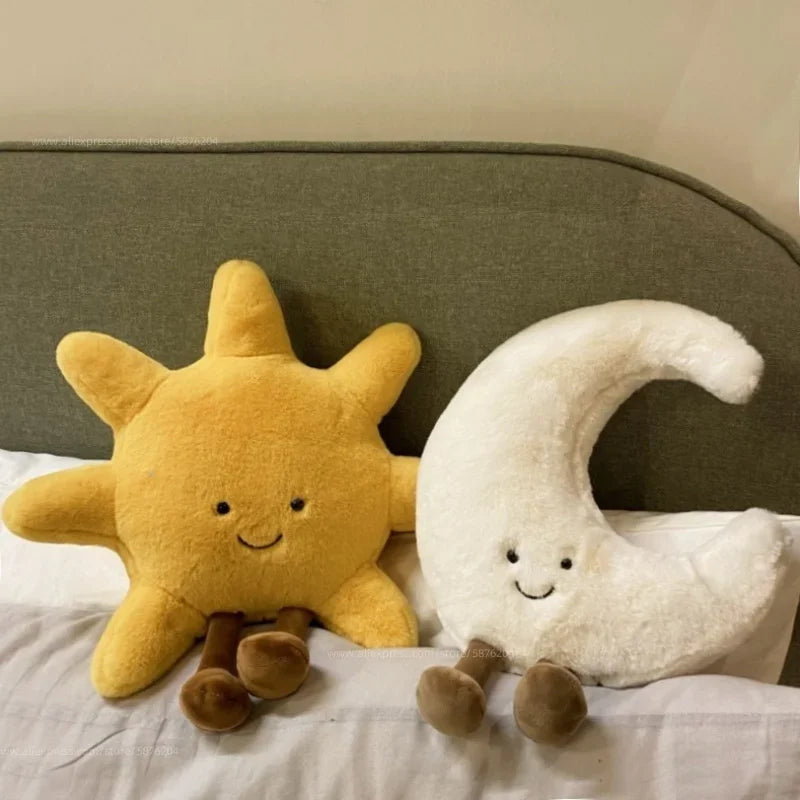 Decorative stuffed animals in the shape of the sun and moon