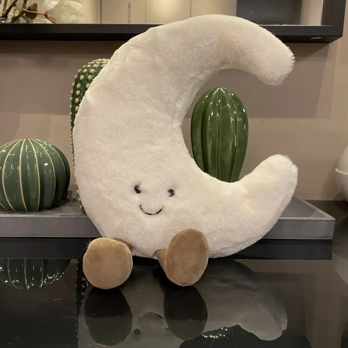 Decorative stuffed animals in the shape of the sun and moon