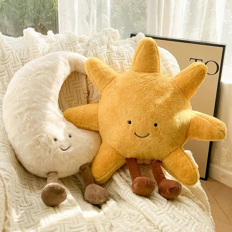 Decorative stuffed animals in the shape of the sun and moon