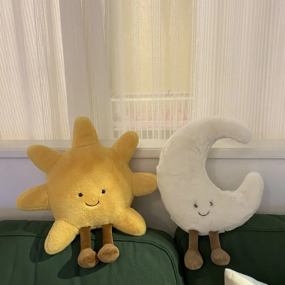 Decorative stuffed animals in the shape of the sun and moon